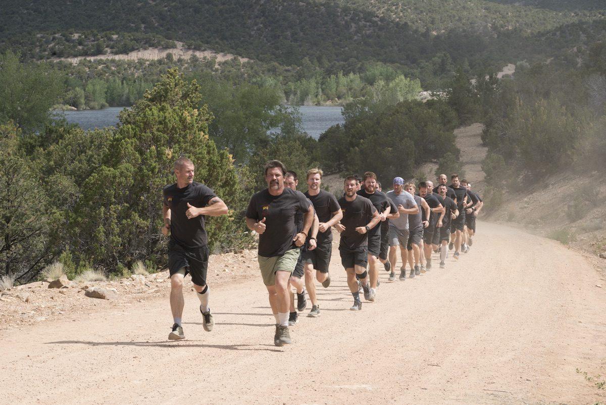 (L–R, front) Jesse Steed (James Badge Dale) and "Supe" Eric Marsh (Josh Brolin) run the Crew 7 members training to become hotshots up the steep road from the lake in “Only the Brave.” (Columbia Pictures/Richard Foreman/Sony Pictures Entertainment)