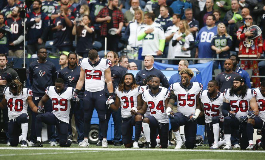 Members of the Houston Texans stand and kneel before the game against the Seattle Seahawks at CenturyLink Field on Oct. 29, 2017 in Seattle, Washington. During a meeting of NFL owners earlier in October, Houston Texans owner Bob McNair said "we can't have the inmates running the prison", referring to player demonstrations during the national anthem. (Otto Greule Jr/Getty Images)