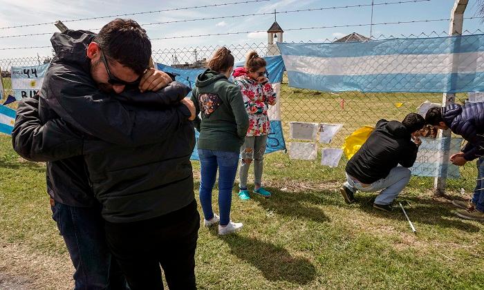 Relatives of crew member Damian Tagliapietra express their grief outside Argentina's Navy base in Mar del Plata, on the Atlantic coast south of Buenos Aires, on Nov. 24, 2017 the day Argentina's navy confirmed an unusual noise heard in the Atlantic near the last known position of a missing submarine appeared to be an explosion, dashing the last hopes of finding the vessel's 44 crew members alive. (Eitan Abramovich/AFP/Getty Images)