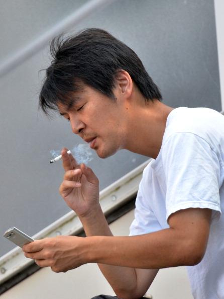 A smoker in Tokyo. Some Japanese companies are introducing new policies to discourage the habit. (Yoshikazu Tsuno/AFP/Getty Images)