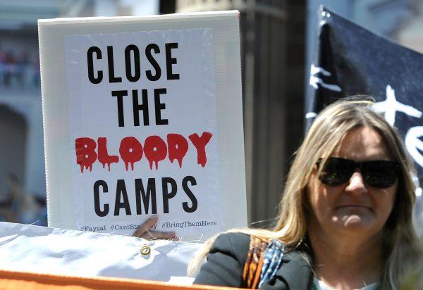 Refugee advocates hold placards and banners during a protest rally in central Melbourne, Australia, November 4, 2017. (AAP/Mal Fairclough/via Reuters)
