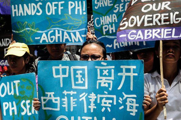 Anti-China protesters mount a protest rally against China's territorial claims in the South China Sea in front of the Chinese Consulate on July 12, 2016 in Makati, Philippines. Philippines brought the case to Permanent Court of Arbitration at The Hague to challenge China’s actions and claims in the South China Sea, which was ruled decisively in favor of the Philippines in July 2016. (Dondi Tawatao/Getty Images)