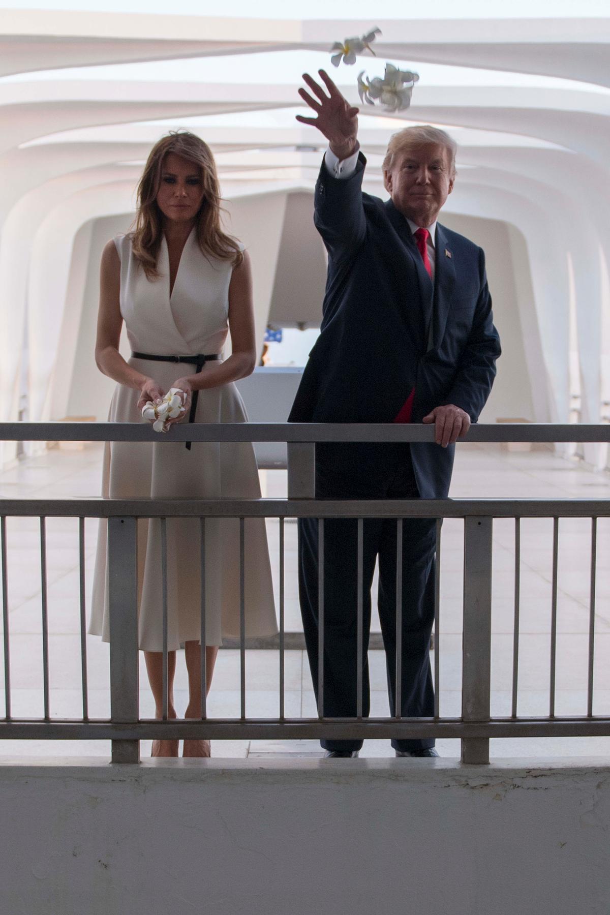 President Donald Trump and First Lady Melania Trump throw flowers during their visit to the USS Arizona Memorial on Nov. 3, 2017. (JIM WATSON/AFP/Getty Images)