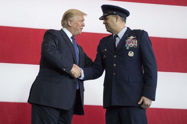 President Donald Trump shakes hands with Commander of US Forces Japan Lt. Gen. Jerry Martinez as he arrives to speak during an event with US military personnel at Yokota Air Base in Tokyo on Nov. 5, 2017. (JIM WATSON/AFP/Getty Images)