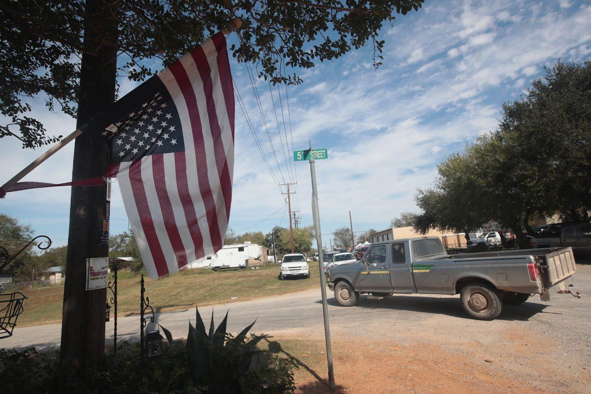 An American flag hangs upside down from a home near the First Baptist Church of Sutherland Springs in Sutherland Springs, Texas, on Nov. 6, 2017.  (Scott Olson/Getty Images)
