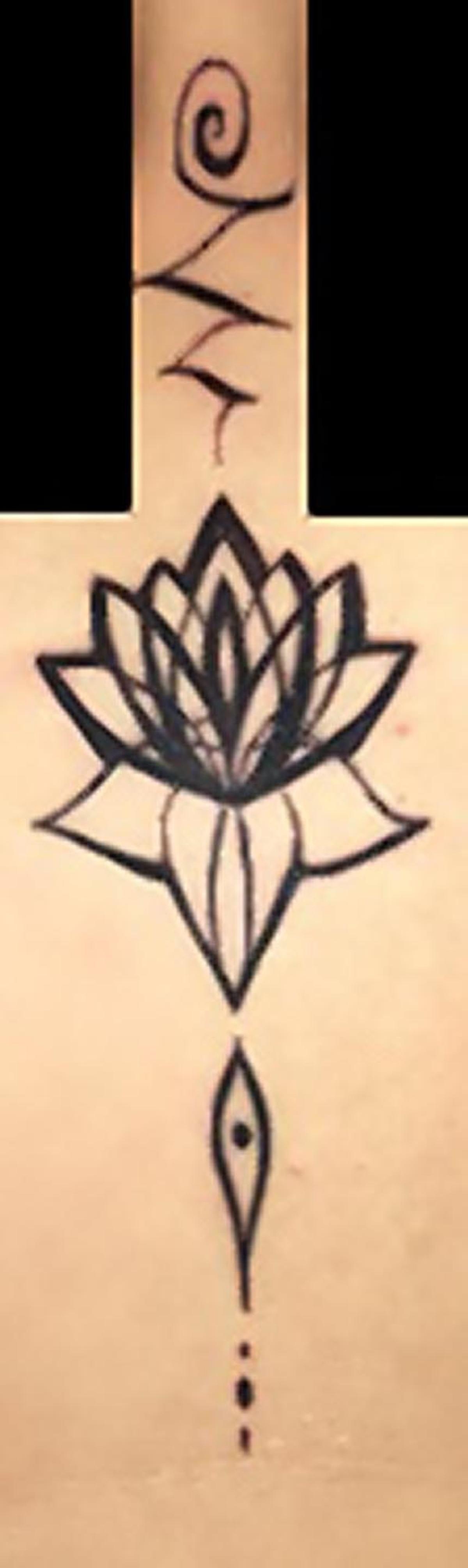 Corinna Slusser has a large black flower tattoo (pictured) on her chest. (DCPI)