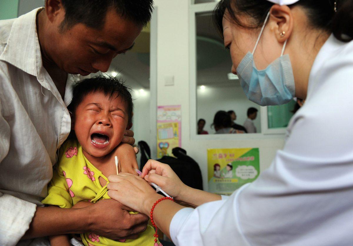 A Chinese boy screams out in pain as he gets inoculated against measles in Hefei City, in eastern China's Anhui Province on Sept. 11, 2010. (STR/AFP/Getty Images)
