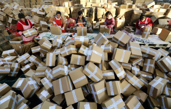 Workers prepare packages for delivery at a sorting center in Lianyungang, Jiangsu Province during the Nov. 11, also known as Single's Day, online shopping festival on November 11, 2016. (STR/AFP/Getty Images)