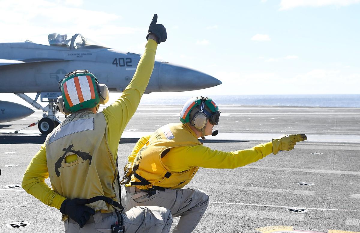 Crewmen launch a US Navy Super Hornet off the deck of the USS Ronald Reagan on July 14, 2017, in Townsville, Australia. (Ian Hitchcock/Getty Images)