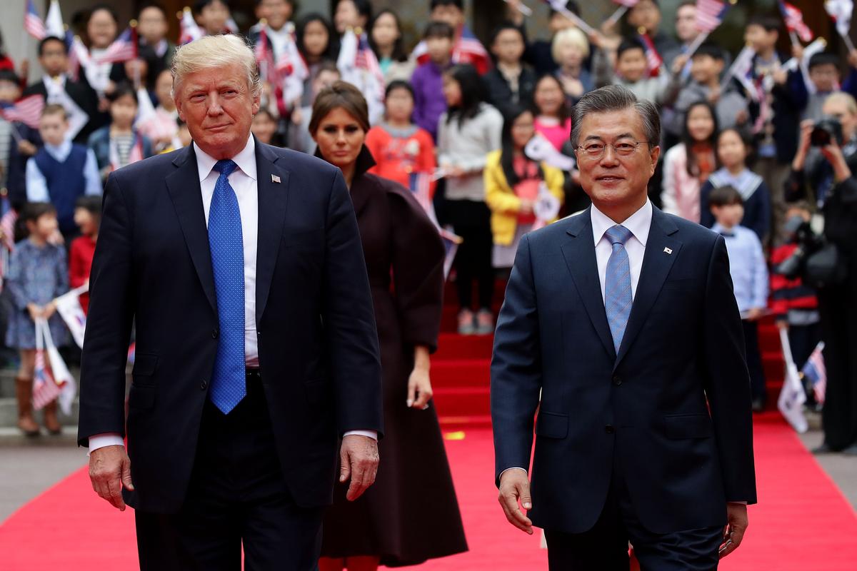 President Donald Trump and South Korean President Moon Jae-In walk towards a guard of honor during a welcoming ceremony at the presidential Blue House in Seoul on Nov. 7, 2017. (Chung Sung-Jun/Getty Images)