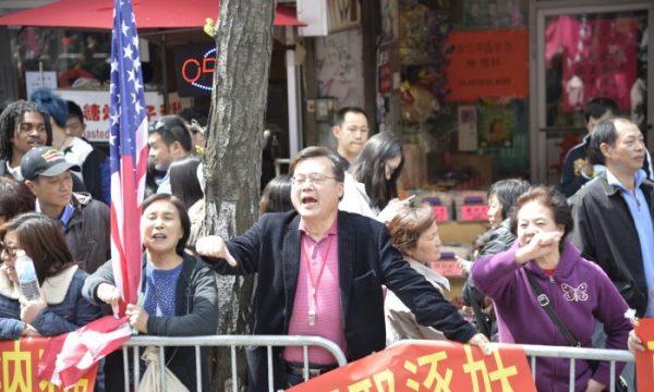 Michael Chu, a Chinese community leader in New York City, yells and curses at Falun Gong practitioners during a parade in Flushing, Queens, New York City, on April 26, 2014. Chu heads an organization devoted to harassing practitioners. (Gary Du/The Epoch Times)