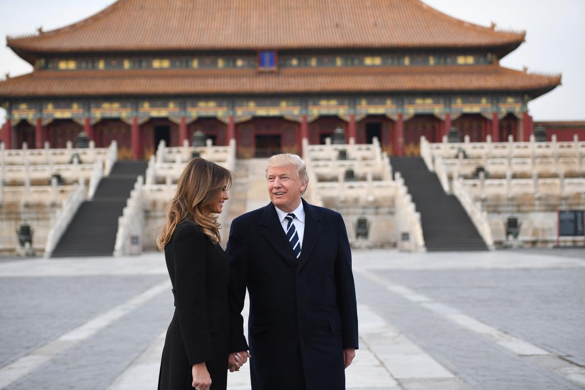 President Donald Trump holds hands with First Lady Melania Trump in the Forbidden City in Beijing on Nov. 8, 2017. (Jim Watson/AFP/Getty Images)