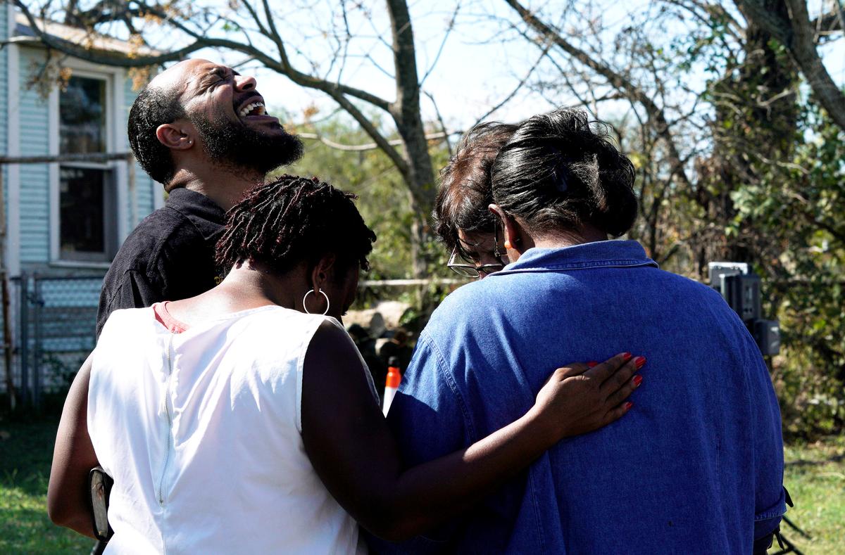 Pastor Oscar Dean prays with others near the site of the shooting. (REUTERS/Rick Wilking)
