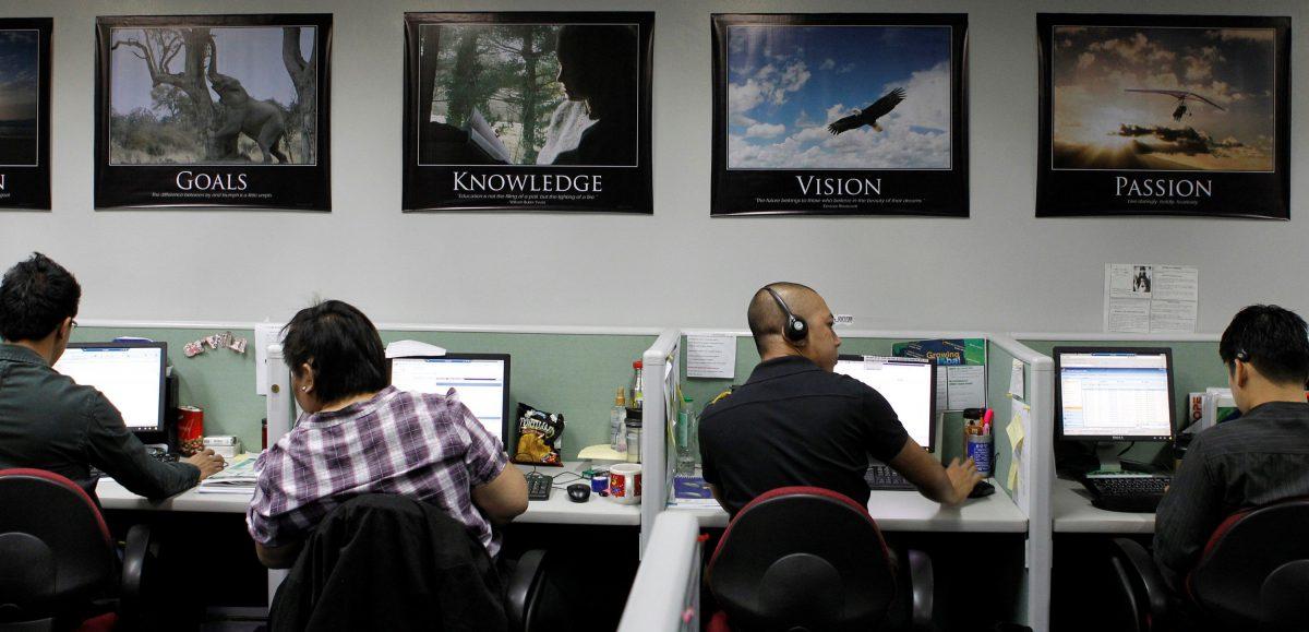Call center agents wait for calls from their United States clients as they work overnight in Manila's Makati financial district Feb. 6, 2012. (REUTERS/Erik De Castro/File Photo)