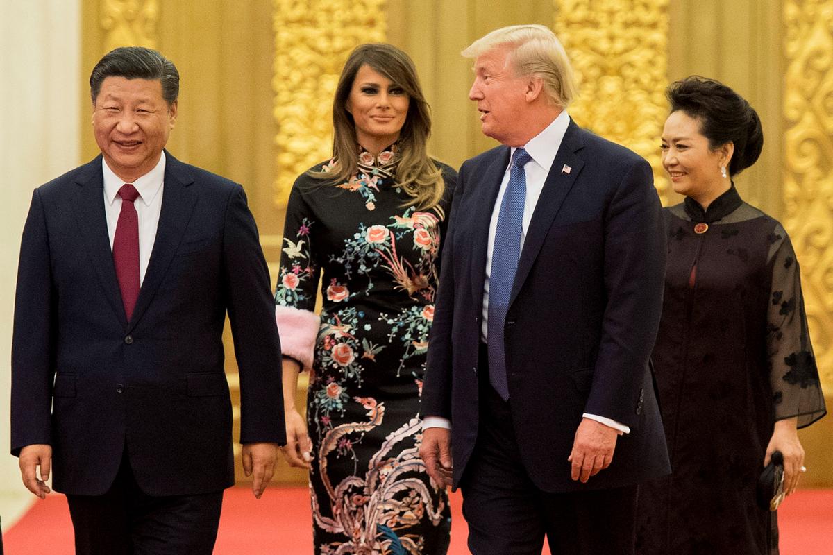 Trump speaks with Xi, as First Lady Melania Trump and Xi's wife Peng Liyuan look on, at the Great Hall of the People in Beijing on Nov. 9, 2017. (Jim Watson/AFP/Getty Images)