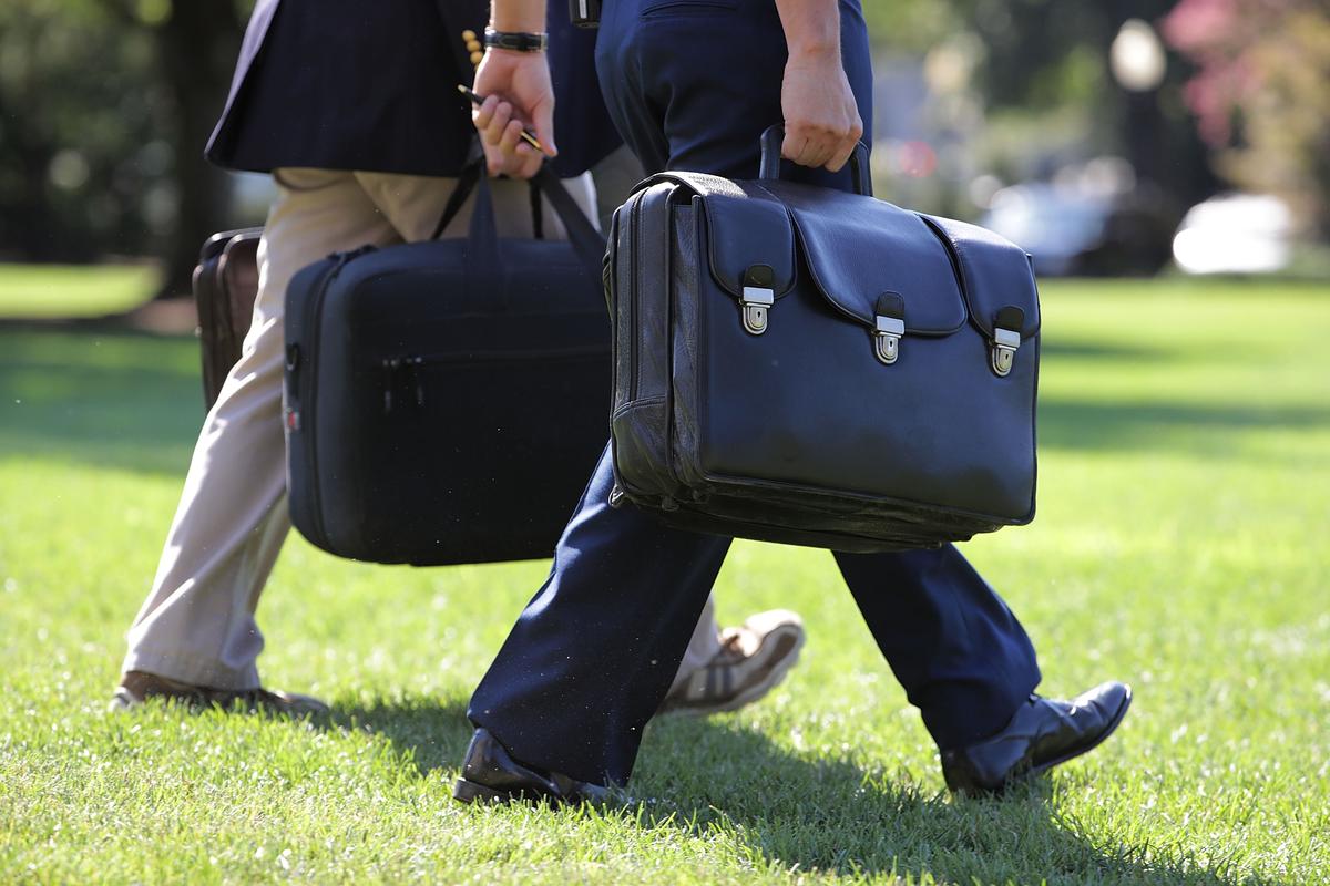 A military aide carries the "football," a case with the launch codes for nuclear weapons, as he follows President Barack Obama across the South Lawn, on Aug. 23, 2016, in Washington. (Chip Somodevilla/Getty Images)