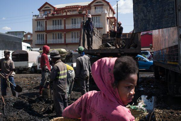 Council workers clear garbage during the clean-up of the market of Anosibe in the Anosibe district, one of the most unsalubrious districts of Antananarivo, Madagascar, on Oct. 10, 2017. (RIJASOLO/AFP/Getty Images)