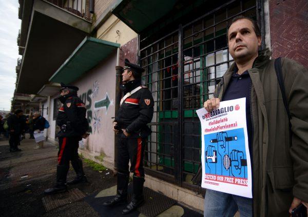 A man holds a placard reading 'No press embargo' as he takes part in a rally of Italian journalists on Nov. 10 in Ostia, in front of a gym owned by Roberto Spada, who was filmed headbutting reporter Daniele Piervincenzi before attacking him with a baton. Piervincenzi had been investigating Spada's alleged links to the far-right CasaPound movement and his nose was fractured in the attack. (FILIPPO MONTEFORTE/AFP/Getty Images)