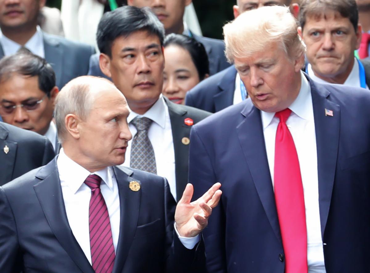 President Donald Trump and Russia's President Vladimir Putin talk as they make their way to take the "family photo" during the Asia-Pacific Economic Cooperation (APEC) leaders' summit in the Danang, Vietnam, on Nov. 11, 2017. (MIKHAIL KLIMENTYEV/AFP/Getty Images)