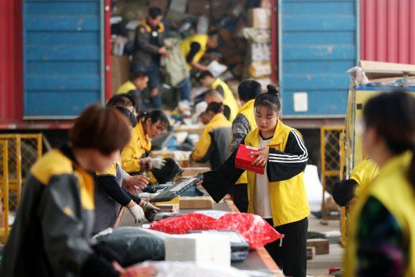Employees sort packages ahead of the Singles' Day online shopping spree in Huaibei City, Anhui Province, China, on Nov. 9, 2017. (STR/AFP/Getty Images)