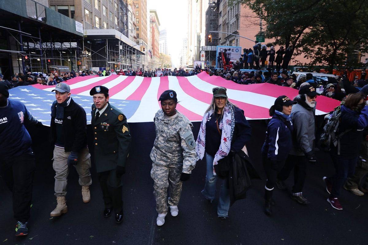 NEW YORK, NY - NOVEMBER 11: Soldiers, veterans and civilians march the Veterans Day Parade on November 11, 2017 in New York City. The largest Veterans Day event in the nation, this year's parade features thousands of marchers, including military units, civic and youth groups, businesses and high school bands from across the country and veterans of all eras. The U.S. Air Force is this year's featured service and the grand marshal is space pioneer Buzz Aldrin. (Photo by Spencer Platt/Getty Images)