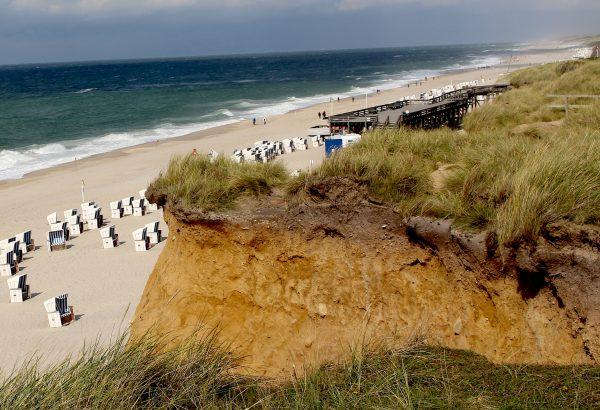 A clifftop view of Sylt's 25-mile-long beach, dotted with hooded wicker chairs. (Janna Graber)