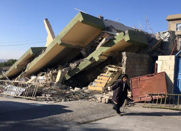 A man walks past a damaged building following an earthquake in Darbandikhan in Sulaimaniya Governorate, Iraq, November 13, 2017. (REUTERS/Ako Rasheed)