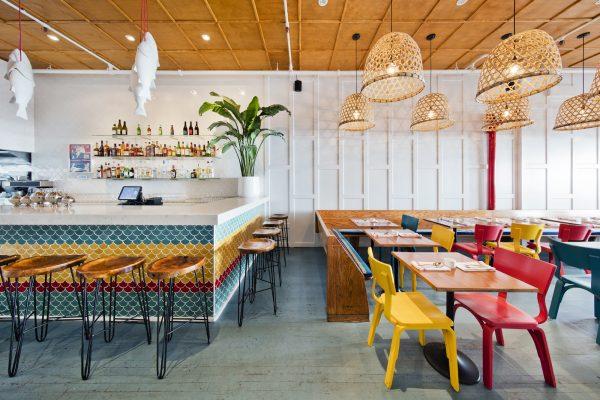 The brightly colored furnishings give the restaurant a sunny and tropical vibe. (Courtesy of Fish Cheeks)