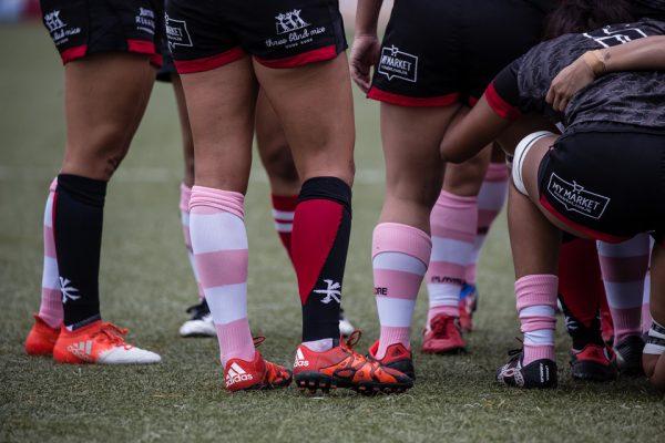 The teams ran out in pink stripped socks to promote awareness of breast cancer. (Dan Marchant)
