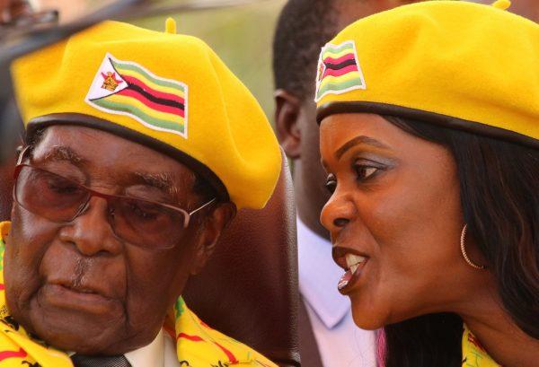 President Robert Mugabe listens to his wife Grace Mugabe at a rally of his ruling ZANU(PF) party in Harare, Zimbabwe, Nov. 8, 2017 in this file photo. (Reuters/Philimon Bulawayo/File Photo)