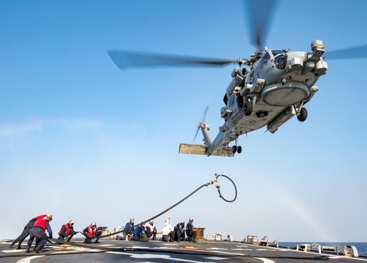 Sailors aboard the Arleigh Burke-class guided-missile destroyer USS Stethem conduct helicopter in-flight refueling operations with an MH-60R Seahawk helicopter as part of the Ronald Reagan Strike Group on Nov. 14, 2017. (U.S. Navy photo by Mass Communication Specialist 2nd Class Jeremy Graham)