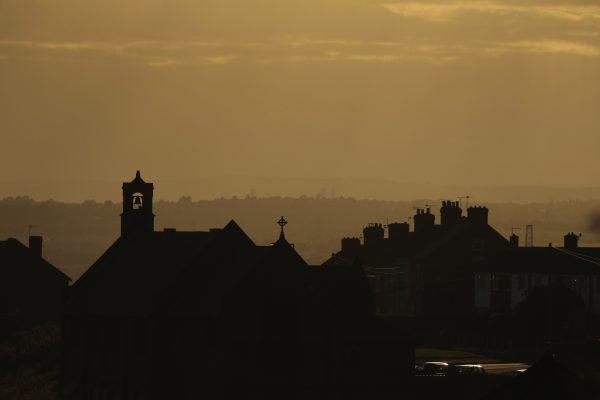 The sun sets over the south Yorkshire town of Rotherham, England, on Sept. 1, 2014. (Christopher Furlong/Getty Images)