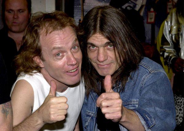 Band members Angus Young (L) and brother Malcolm Young of the Australian rock band AC/DC on Sept. 15, 2000, at the Rock Walk handprint ceremony at the Guitar Center in Hollywood, Calif. (Photo /Newsmakers)
