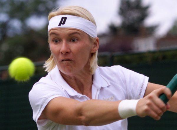 Jana Novotna plays a return to France's Nathalie Dechy during their fourth round match at the Wimbledon Tennis Championships (Reuters/File Photo)
