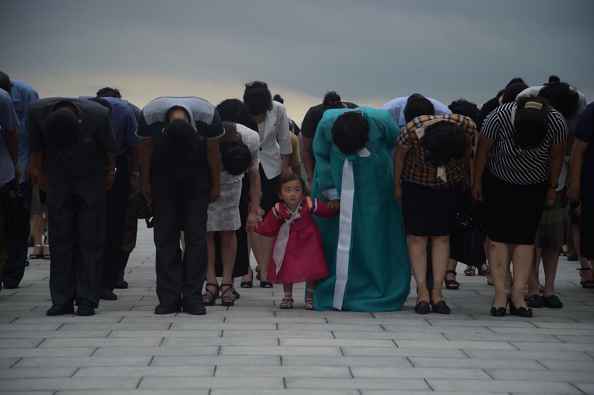 Pyongyangites bow before the statues of presidents Kim Il Sung and Kim Jong Il on Mansu Hill on the 23rd anniversary of Kim Il Sung's death in Pyongyang on July 8, 2017. (KIM WON-JIN/AFP/Getty Images)