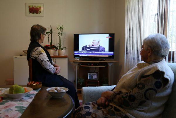 Bida Smajlovic 65, who lost her brother and husband along with more than 50 members of her close family and Vasva Smajlovic 74, who lost her husband and the husband of her daughter along with more than 30 members of her close family watch a television broadcast of the court proceedings of former Bosnian Serb general Ratko Mladic in Potocari near Srebrenica, Bosnia and Herzegovina, November 22, 2017. (Reuters/Dado Ruvic)