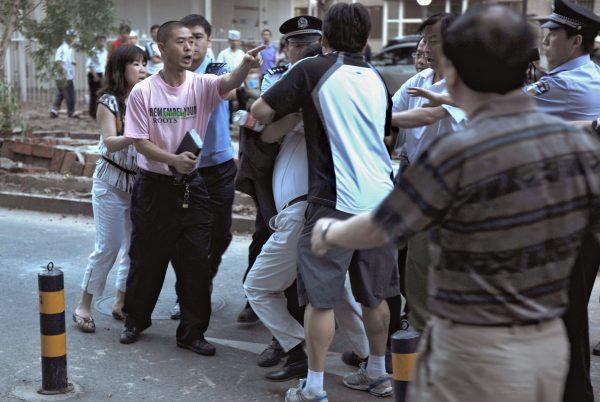 Local residents scuffle with police in Beijing on May 31, 2010. The locals claim the land being demolished belongs to their community and was illegally built upon by a property developer.(STR/AFP/Getty Images)