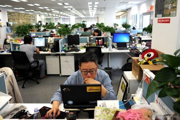 A man using a laptop at an office of Weibo, China's version of Twitter, in Beijing, on April 16, 2014. (Wang Zhao/AFP/Getty Images)