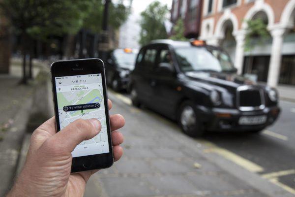 A smartphone displays the Uber mobile application which allows users to hail private-hire cars from any location on June 2, 2014 in London, England. (Oli Scarff/Getty Images)