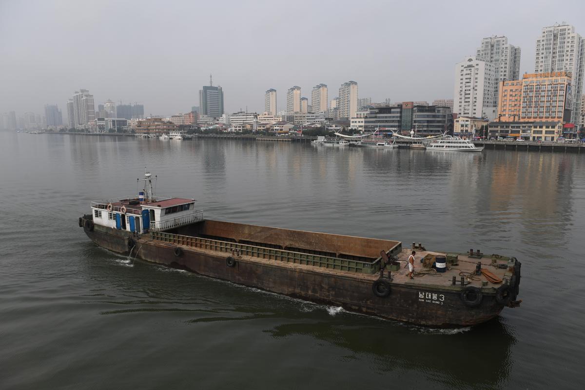 A North Korean ship passes in front of the waterfront of the Chinese border city of Dandong, in China's northeast Liaoning province, opposite the North Korean town of Sinuiju on Sept. 4, 2017. (GREG BAKER/AFP/Getty Images)