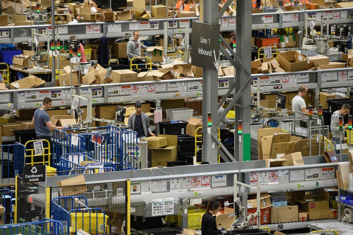 Members of staff process purchased items in the Amazon Fulfilment centre on Nov. 15, 2017 in Peterborough, England. A report in the US has suggested that over half of all online purchases this Christmas will be made with Amazon. (Leon Neal/Getty Images)
