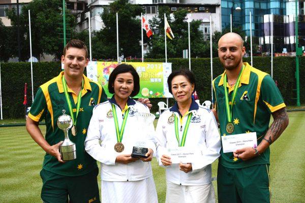 The Australia and Thailand team proudly display the pairs trophies they won at the Hong Kong International Bowls Classic last Sunday, November 19 at Kowloon Bowling Green Club. Photo shows (from left) Ben Twist, Songsin Tsao, Jintana Visanuvimol and Jesse Noronha. (Stephanie Worth)