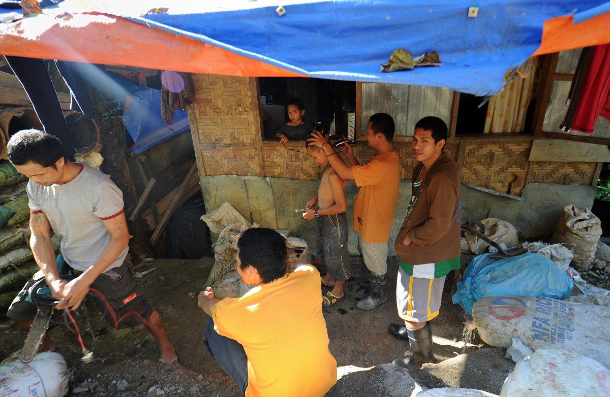 This photo taken shows residents getting their hair cut at an improvised barber shop at the village of Mt. Diwata, in the town of Monkayo in the Compostela Valley, on the southern Philippine island of Mindanao on July 17, 2012. Mt. Diwata or "Diwalwal" as it is commonly known, lies 70 kilometers north of the trading city of Davao, and accessible only via motorcycle. In the 1980's it was a logging area, but the discovery of gold by a tribesman turned it into a gold rush site, which drew labourers, farm workers, ex-soldiers and former guerrillas from all over the country, all seeking to get rich. The Philippines is believed to have some of the biggest mineral reserves in the world -- the government estimates the country has at least 840 billion USD in gold, copper, nickel, chromite, manganese, silver and iron ore deposits, but the minerals have been largely untapped, partly because of a strong anti-mining movement led by the influential Catholic Church. (Ted Aljibe/AFP/GettyImages)