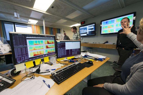 Met office staff confer as computer screens show seismic activity from the Bardarbunga volcanic eruption at the Icelandic met office in Reykjavik on August 23, 2014. (Halldor Kolbeins/AFP/Getty Images)