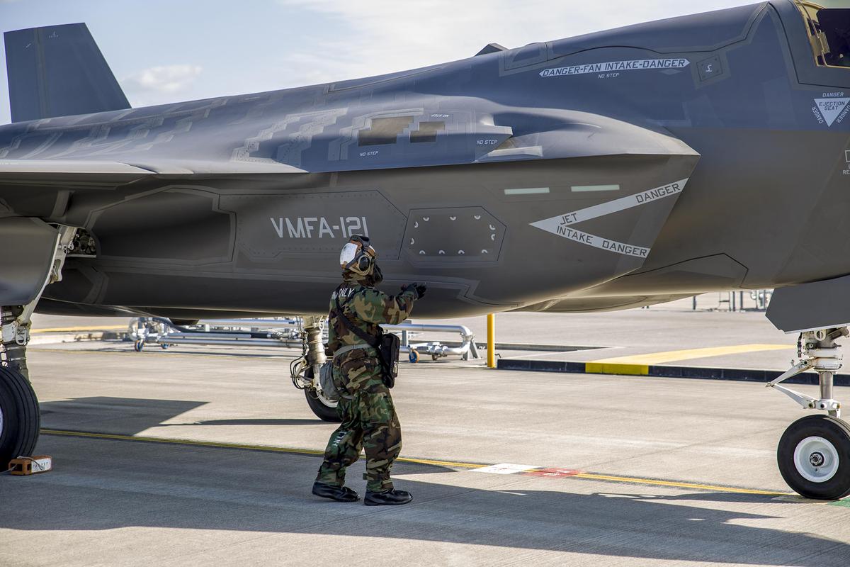 A U.S. Marine Corps Cpl. prepares to fuel an F-35B Lightning II while wearing Mission Oriented Protective Posture gear level four during a training exercise at Marine Corps Air Station Iwakuni, Japan, Nov. 15, 2017. The exercise trains Marines to keep aircraft in the fight while working inside a simulated-hazardous environment. (Cpl. Carlos Jimenez)