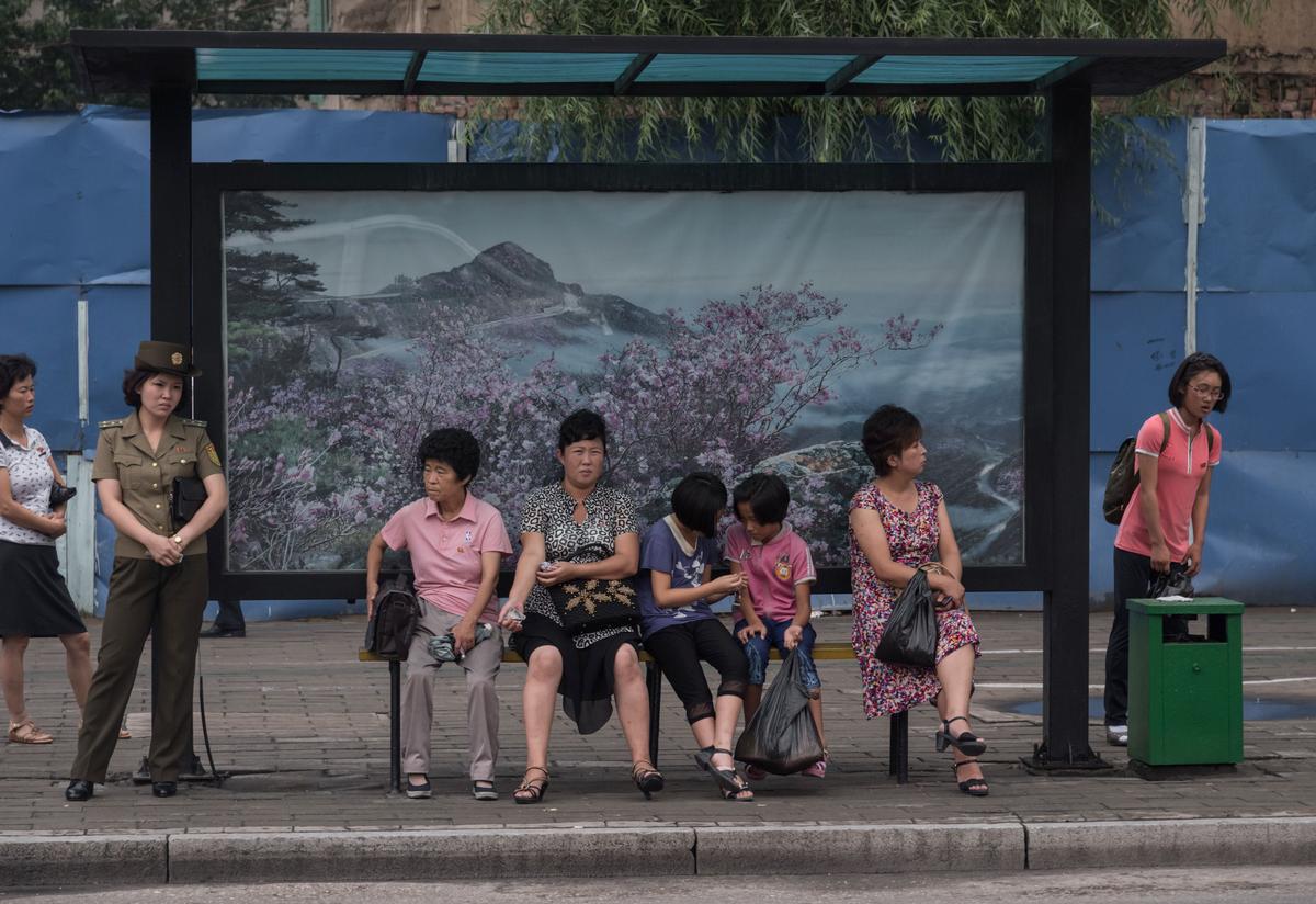North Koreans wait at a trolleybus stop in Pyongyang on July 28, 2017. A new decree in North Korea bans drinking in groups larger than three in an effort to curb prohibited political talk. (ED JONES/AFP/Getty Images)