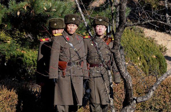 North Korean soldiers look at South next to a spot where a North Korean defected crossing the border as South Korean Defense Minister Song Young-moo visit in Panmunjom, South Korea, on Nov. 27, 2017. (Korea Pool/Getty Images)