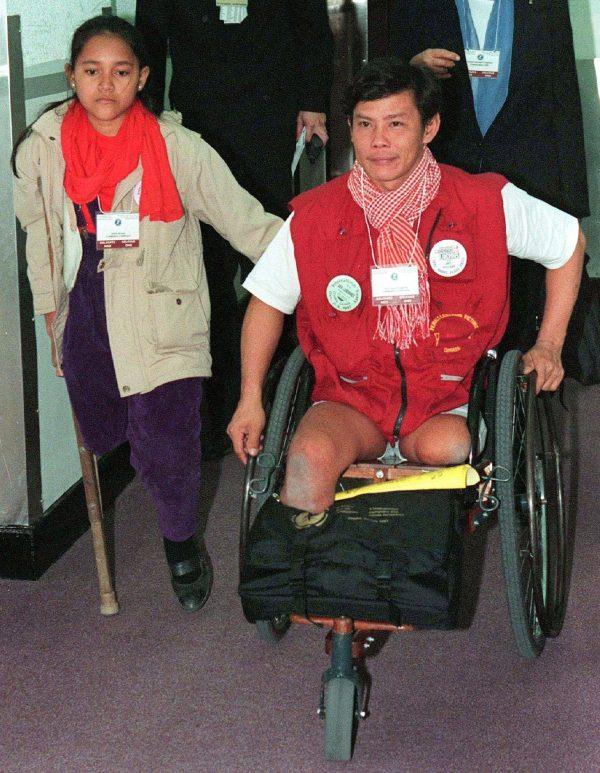 Kosal Song (L) and Tun Channareth, both landmine victims from Cambodia, leave the landmine action forum roundtables in Ottawa on Dec. 2, 1997. (CP PHOTO/Jonathan Hayward)