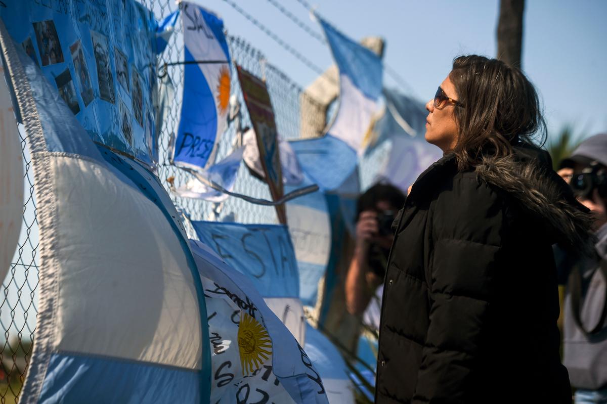 A relative of missing submariner Celso Oscar Vallejos looks at supportive messages for the 44 crew members of Argentine missing submarine hanging outside Argentina's Navy base in Mar del Plata, on the Atlantic coast south of Buenos Aires, on Nov. 23, 2017. (EITAN ABRAMOVICH/AFP/Getty Images)