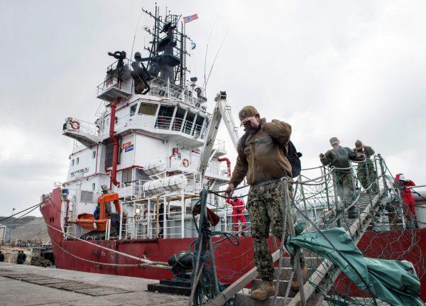 Members of the U.S. Navy Undersea Rescue Command (URC) disembark from the Sophie Siem vessel moored at Comodoro Rivadavia harbor to support the search and rescue efforts for the Argentine missing submarine ARA San Juan in Comodoro Rivadavia, Chubut Province, Argentina, on Nov. 26, 2017. (Pablo Villagra/AFP/Getty Images)